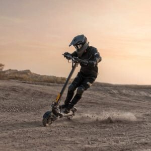 Rider kicking up dust on the Ausom F1 Max at sunset — off-road action shot