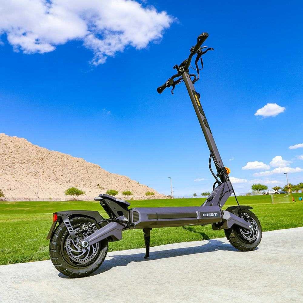Ausom DT2 Pro electric scooter parked outdoors under blue sky — rear three-quarter view