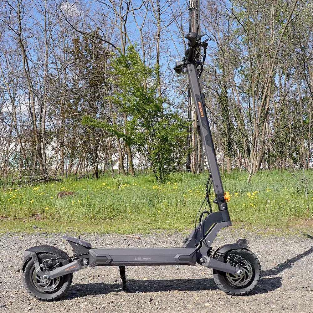 Ausom L2 Max Dual Motor electric scooter parked on a gravel trail — outdoor side view