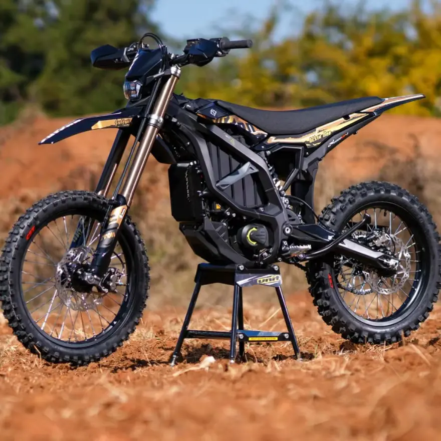 Surron Ultra Bee electric dirt bike on a stand in the dirt