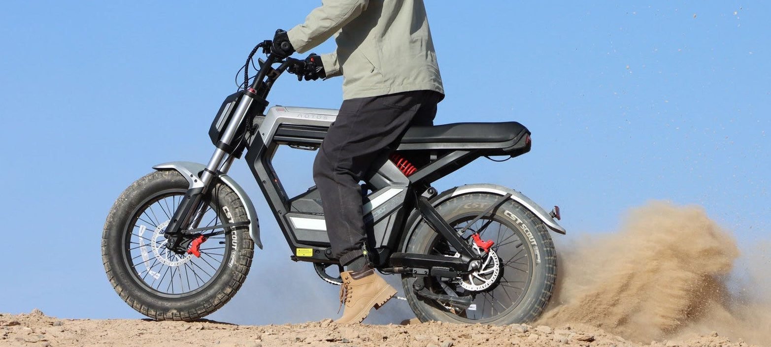 Rider kicking up dust on an AOTOS FLUX X26 fat tire electric bike
