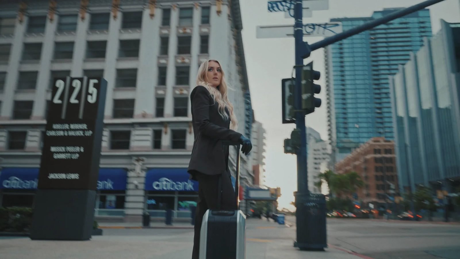 Traveler with an AOTOS L2 smart rideable suitcase on a city street
