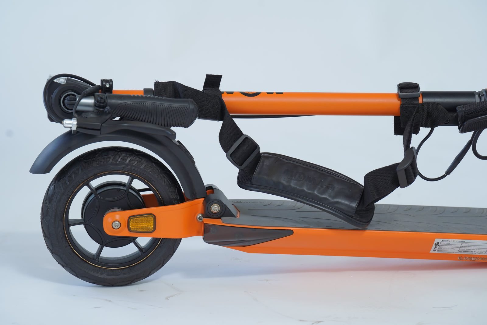 Shoulder strap attached to a folded electric scooter