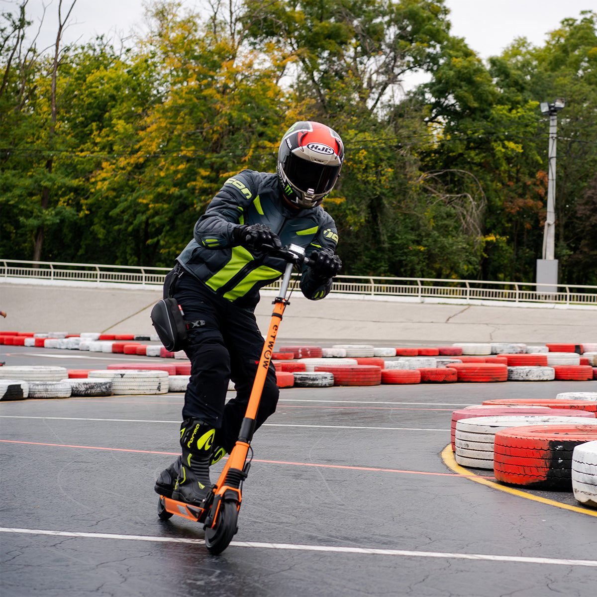 Rider on an orange E-TWOW GT Sport electric scooter