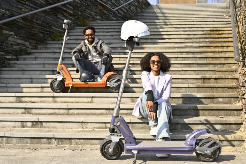 Orange and purple TK3 electric scooters on steps