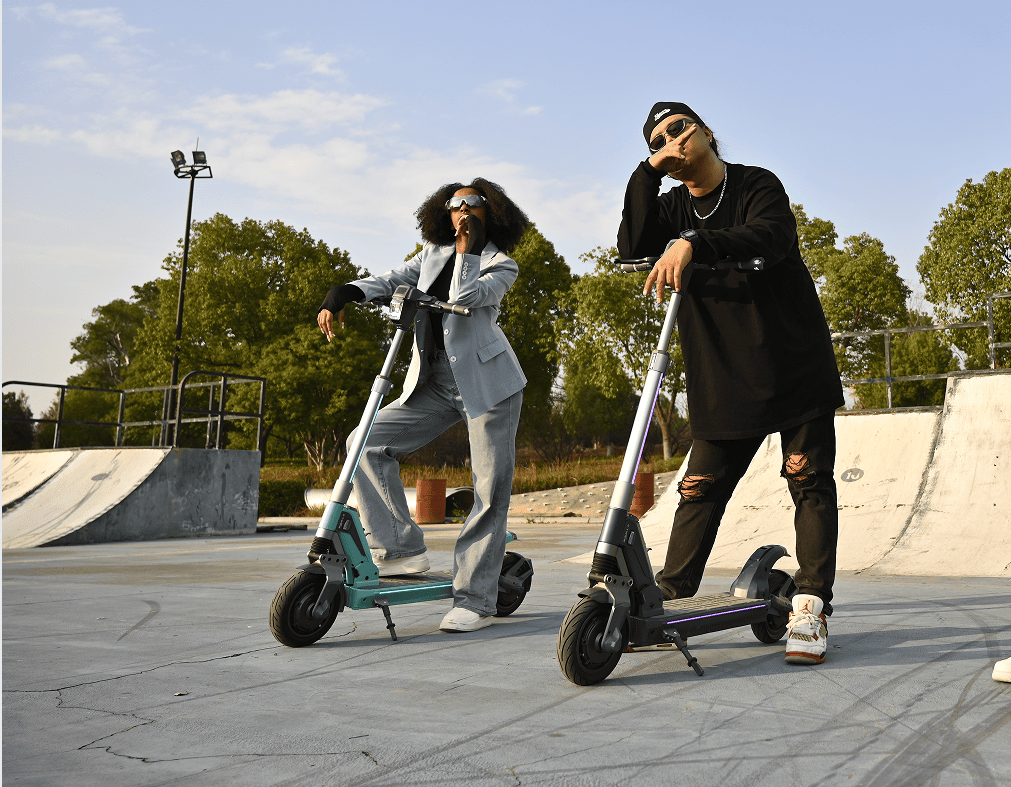 Two riders with TankTorq TK3 electric scooters at a skate park