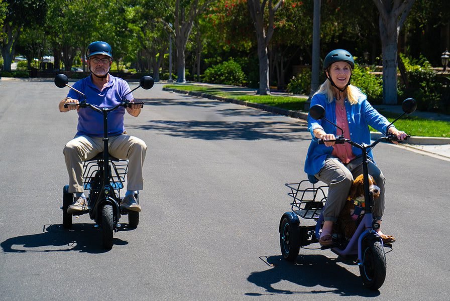 Riders on a Gyroor C5 electric trike and a Gyroor sit-down electric scooter