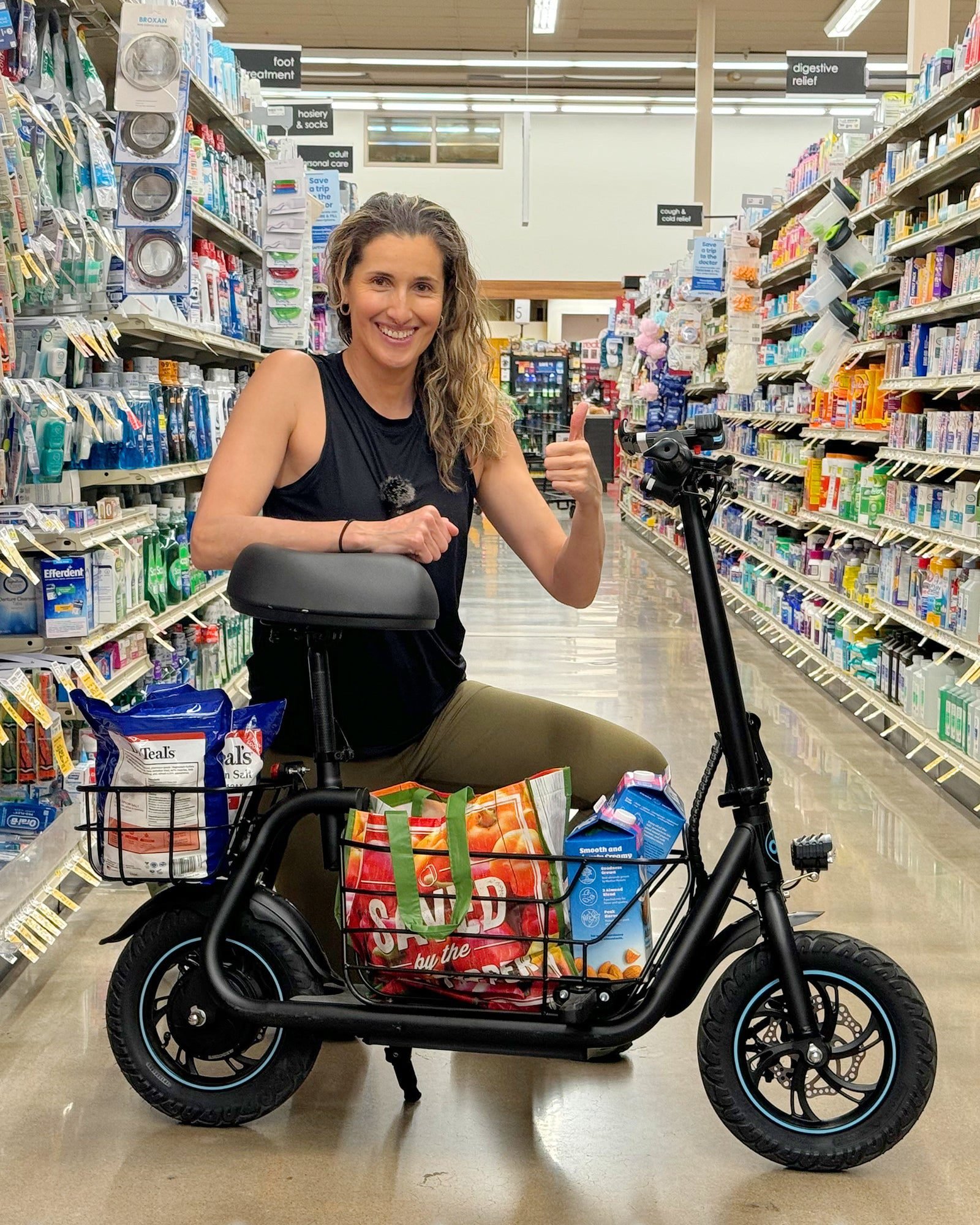 Rider with shopping in the C1S seated scooter baskets