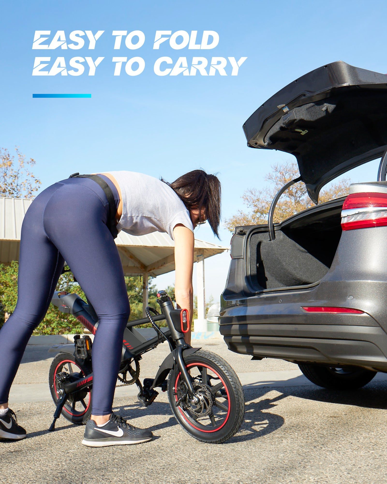 14-inch folding electric bike lifted into a car trunk