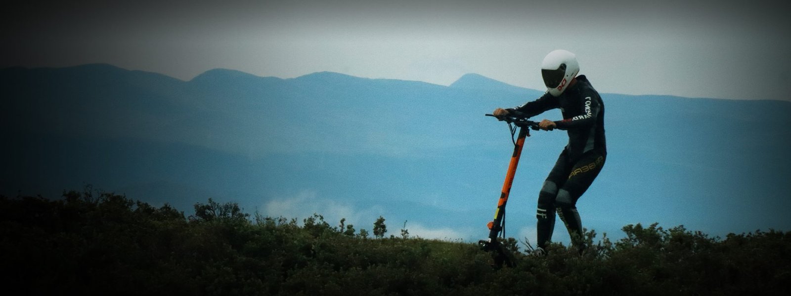 Rider walking the G3 Pro on a hilltop