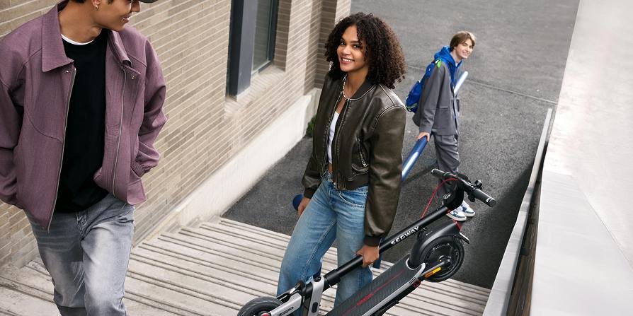 Folded electric scooter carried onto a train