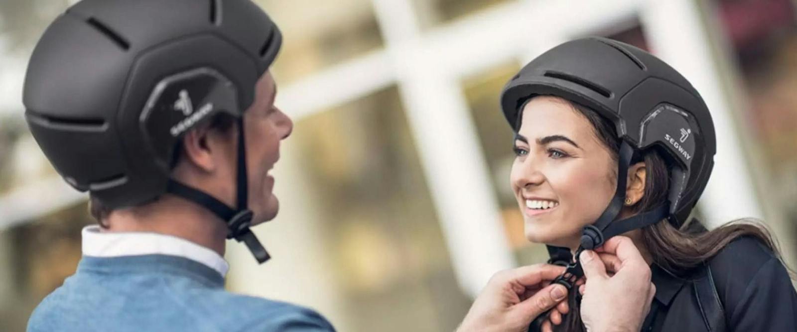 Two riders wearing Segway helmets